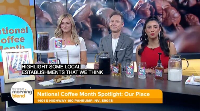 Three hosts sit at a table with coffee drinks and syrups, on a TV show set for National Coffee Month.