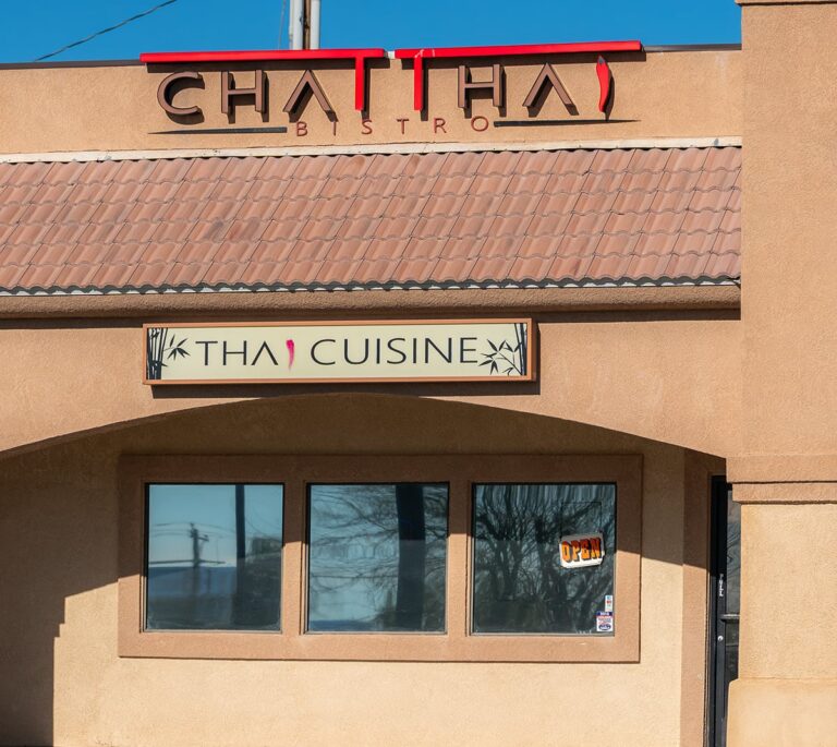 Exterior of a restaurant with signs reading Chat Thai Bistro and Thai Cuisine above the windows.