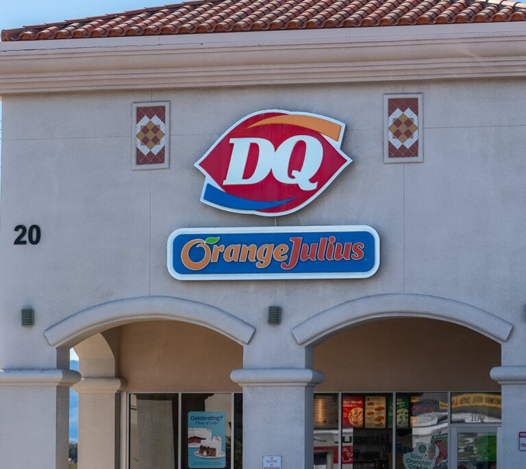 Storefront with Dairy Queen (DQ) and Orange Julius signs above arched entrances.
