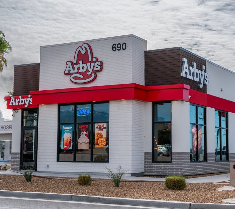 Arbys restaurant exterior with signs, large windows, and a visible street number 690.
