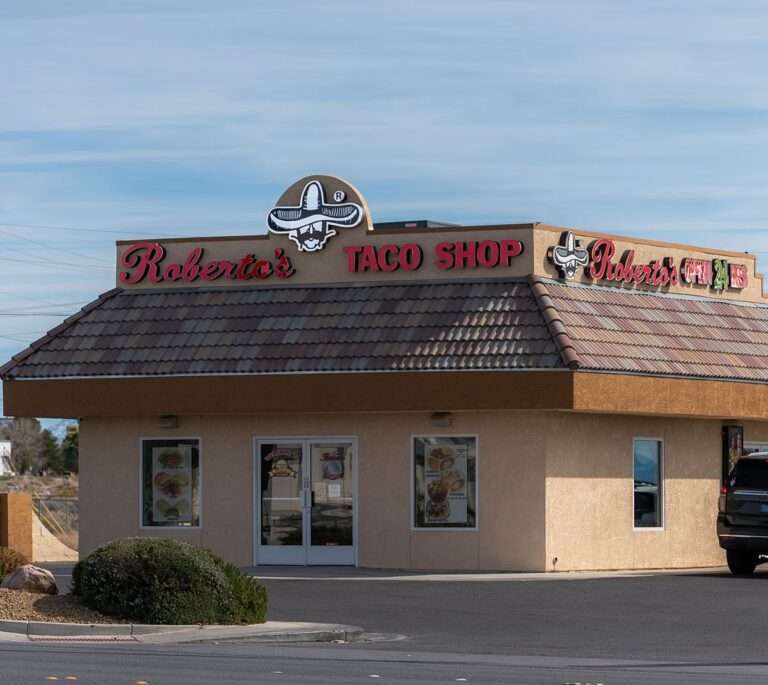 Roberta’s Taco Shop restaurant with a brown tiled roof and signage on a sunny day.